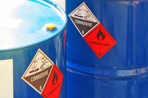 chemical containers with corrosive and flammable warning stickers