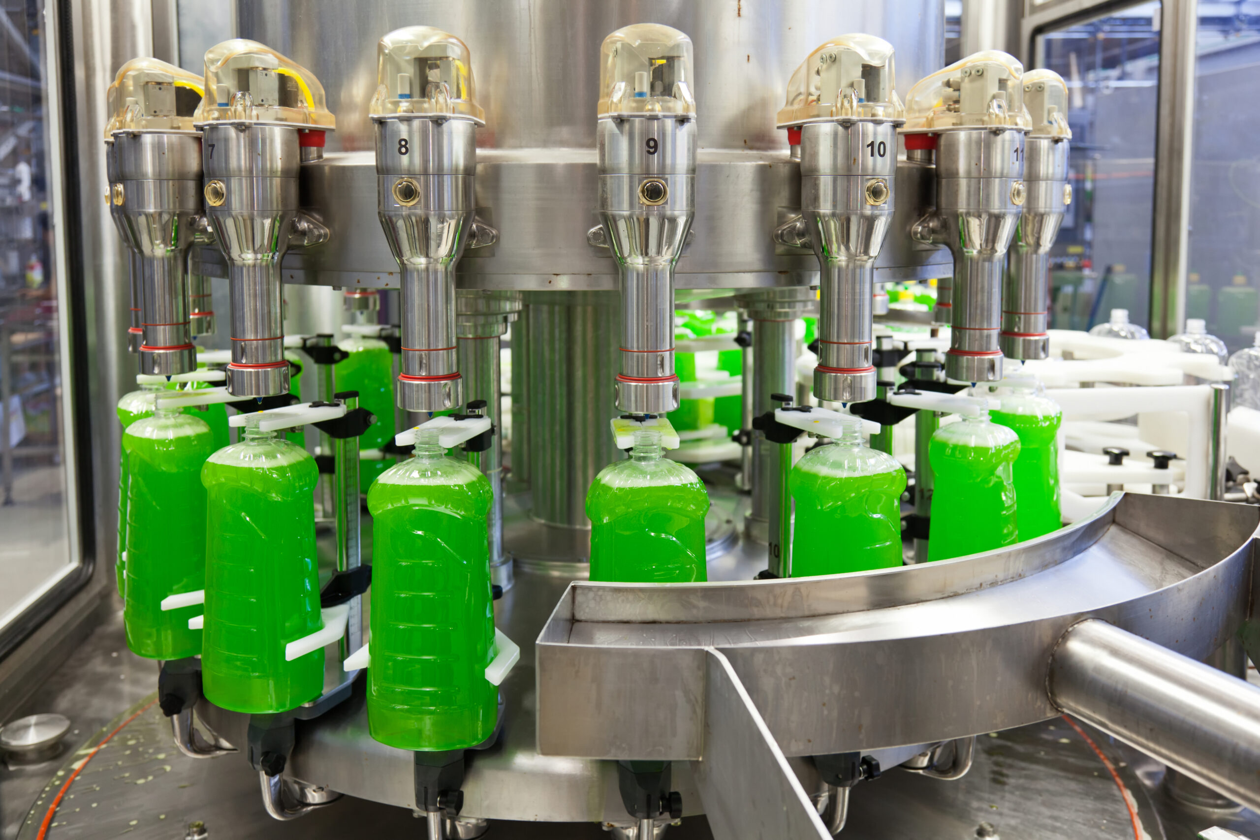 Green liquid filling on a bottling line